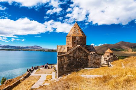 Scenic view of an old Sevanavank church in Sevan, Armenia on sunny day blue sky and fluffy cloudsの写真素材