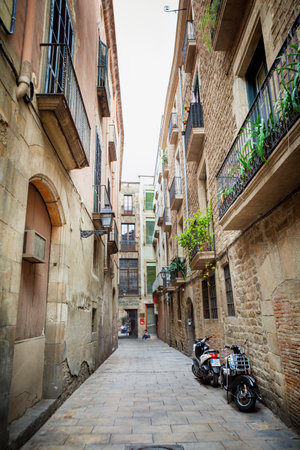 Barcelona, Spain - April 17, 2016: Medieval buildings in the Gothic and Born distric, narrow streetのeditorial素材