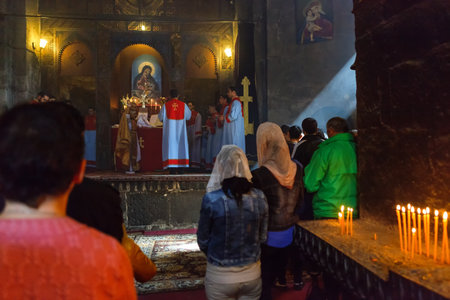 Sevan, Armenia - 25 September, 2016: Morning Mass liturgy male choir in interior of Surb Araqeloc and Astvatsatsin old Sevanavank church monasteryのeditorial素材