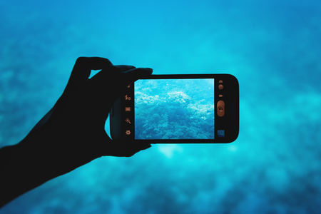 photographing with a smartphone in the red sea in bathyscaphe tripの写真素材