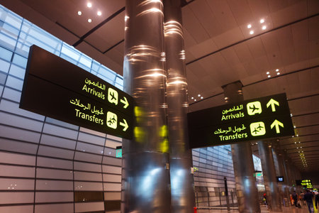Doha, Qatar - 14 February, 2017: Interior of Hamad International Airport Terminal. Arrival transfer signs close upのeditorial素材