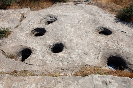 Prehistorical petroglyphs in Qobustan, Azerbaijan. Qobustan park of prehistorical petroglyphs near Caspian sea. holes in the rock. listed by UNESCO as World Heritage.のeditorial素材