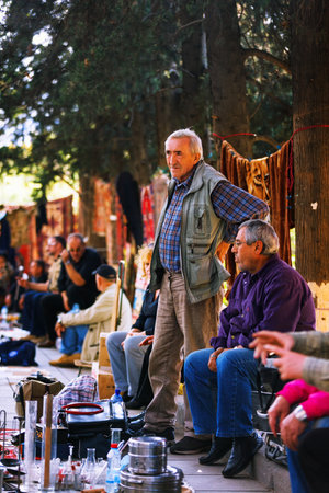Tbilisi, Georgia - 08 October, 2016: An unidentified seller on Dry Bridge Flea market in Tbilisi sells Soviet badges and icons, retro junk stuff, tableware set, dishesのeditorial素材