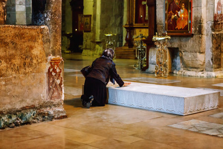 Mtskheta, Georgia - October 4, 2016: Morning prayer, people in Interior of Svetitskhoveli Orthodox Cathedral in Mtskheta, Georgia. Church with mural of zodiacのeditorial素材