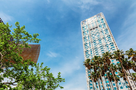 Barcelona, Spain - 22 April, 2016: Skyscrapers around Barceloneta neighbourhood during sunny day on the beach boulevardのeditorial素材