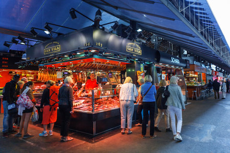 Barcelona, Spain - 20 April, 2016: People shop In Barcelona Market (Mercat de Sant Josep de la Boqueria), a large public market and a tourist landmark with entrance from La Rambla streetのeditorial素材