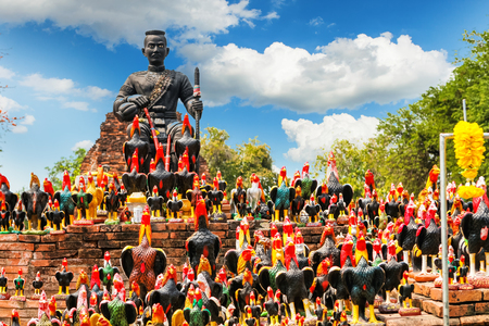 Statue of black Buddha head guarded by hundreds of roosters at Wat Thammikarat temple in Ayutthaya Province, Thailand Also called rooster templeの写真素材