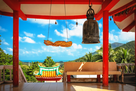 Beautiful view of Chinese Sangthom Temple of the Goddess of Mercy Shrine in Chaloklum, Ko Pha Ngan, Thailand Showing the ornate, orange roof of the main pagoda and the surrounding jungle.の写真素材