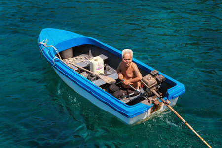 Koh Lang Ka Jew - 9 February, 2014: Old fisherman on the boat in Koh Lang Ka Jew, Chumphon Marine National Park sailsのeditorial素材