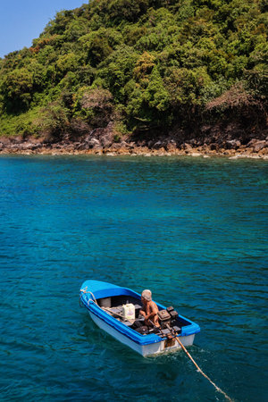 Koh Lang Ka Jew - 9 February, 2014: Old fisherman on the boat in Koh Lang Ka Jew, Chumphon Marine National Park sailsのeditorial素材