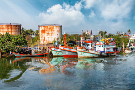 Chumphon, Thailand - 9 February 2014: Fishing boats at the coastal fishing villages. Preparation sea fishing. Sailing by Chumphon riverのeditorial素材
