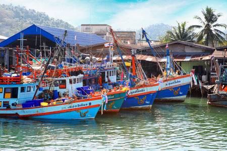 Chumphon, Thailand - 9 February 2014: Fishing boats at the coastal fishing villages. Preparation sea fishing. Sailing by Chumphon riverのeditorial素材