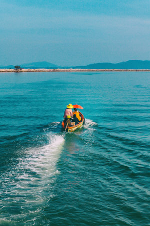 Chumphon, Thailand - 9 February 2014: Fishing boats at the coastal fishing villages. Preparation sea fishing. Sailing by Chumphon river. entering the sea along the pierのeditorial素材
