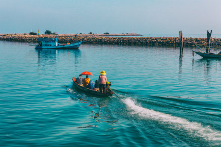 Chumphon, Thailand - 9 February 2014: Fishing boats at the coastal fishing villages. Preparation sea fishing. Sailing by Chumphon river. entering the sea along the pierのeditorial素材