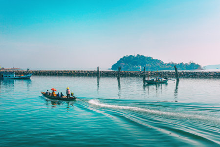 Chumphon, Thailand - 9 February 2014: Fishing boats at the coastal fishing villages. Preparation sea fishing. Sailing by Chumphon river. entering the sea along the pierのeditorial素材