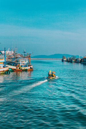 Chumphon, Thailand - 9 February 2014: Fishing boats at the coastal fishing villages. Preparation sea fishing. Sailing by Chumphon river. entering the sea along the pierのeditorial素材