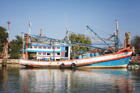 Chumphon, Thailand - 9 February 2014: Fishing boats at the coastal fishing villages. Preparation sea fishing. Sailing by Chumphon riverのeditorial素材