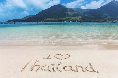 I love heart Thailand letters word written on the beach sand. Crystal blue water of the seaの写真素材