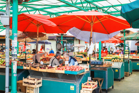 Belgrade, Serbia - 19 July, 2016: Different people at a farmers market buy and check grocery at...