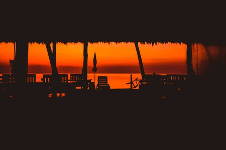 Sunset at beach bar no people silhouette of the restaurantの写真素材