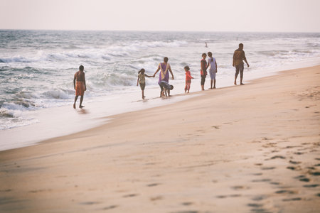 Odayam, India - February 13, 2016: Indian Family plays and walks on beach, Odayam near Varkala, Keralaのeditorial素材