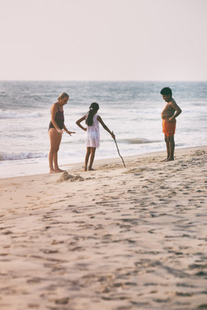 Odayam, India - February 13, 2016: Indian Family plays and walks on beach, Odayam near Varkala,...