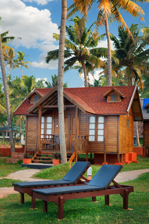 Varkala, India - February 09, 2016: big luxury wooden bungalow street in the tropical resort, palm tree alley, idylic place in Indiaのeditorial素材