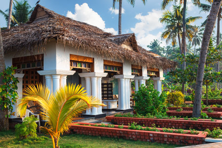 Varkala, India - February 09, 2016: big luxury bungalow with columns white exterior entrance in the tropical resort, palm tree alley, idylic place in Indiaのeditorial素材