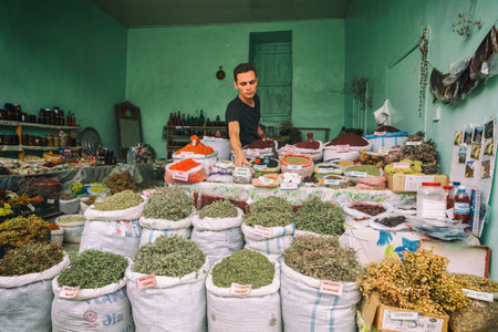 Lahic, Azerbaijan - July 18, 2015: Portrait of market vendor. Bags of dried herbal tea, spices for sale at city local market. Lahic. Azerbaijanのeditorial素材