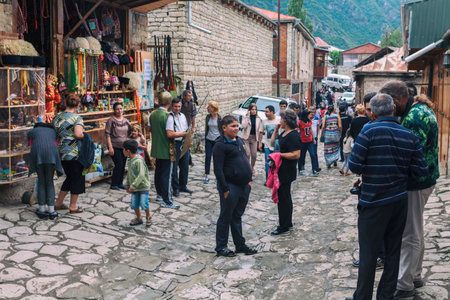Lahic, Azerbaijan - July 18, 2015: Street view on cobblestone Huseynov street, the main street of Lahic mountainous village of Azerbaijan, with buildings, shops and people.のeditorial素材