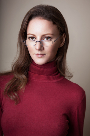 Woman Wearing Glasses in red sweaterb turtle neckの写真素材
