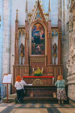 Krakow, Poland - April 15, 2018: women pray in The side altar, praying stalls and benches in the Roman Catholic church of St. Catherine of Alexandria, Augustinian Monastery interiorのeditorial素材