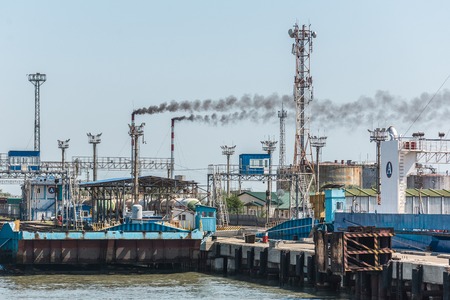 Factory chimney smoking, heavy black smoke on the sky.の写真素材