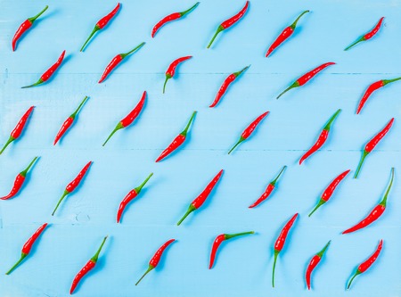 Red hot chili peppers on old blue wooden tableの写真素材