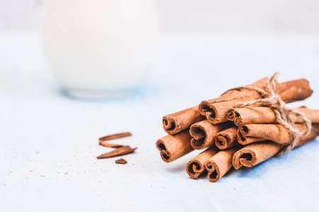 Ground cinnamon, cinnamon sticks, tied with jute rope on old wooden background in rustic style selective focusの写真素材