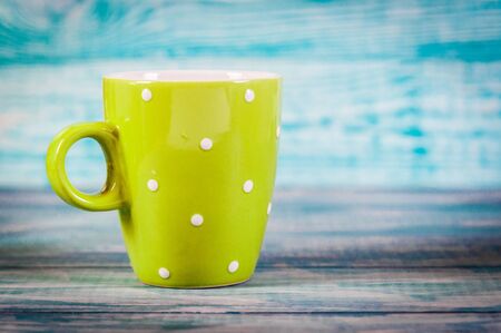 Coffee cup with dots good morning on blue rustic background, breakfast on Mothers day or Womens day. Free space for your textの写真素材