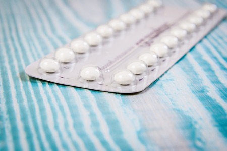 Contraceptive Pill with English Instructions.. Wooden vintage blue background, free space for text.の写真素材