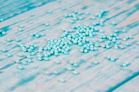 Sugar sprinkle dots, light blue decoration for cake and bekery, a lot of sprinkles as a backgroundの写真素材