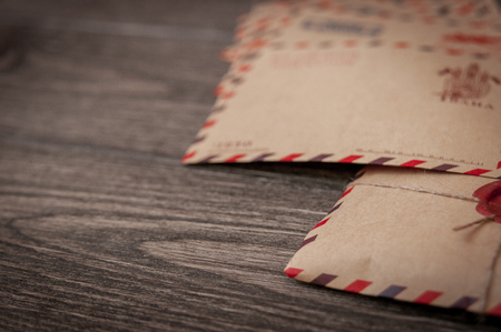 Old vintage retro envelopes with a wax stamp on old dark brown wooden table