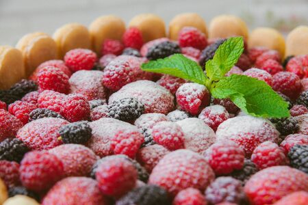 The summer biscuit naked bargaining with cream of mascarpone and fresh berries on a wooden background.の写真素材