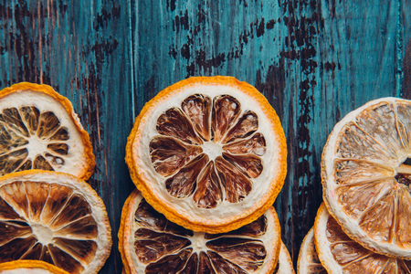 Dried orange slices on a wooden table, selective focus and toned imageの写真素材