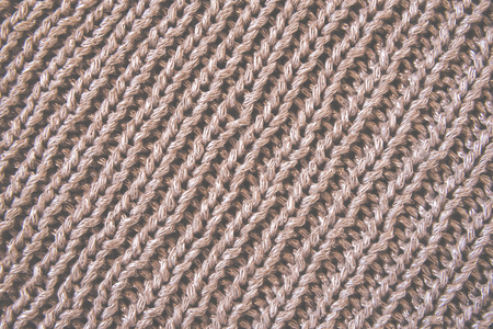 Knitted woolen brown texture background. Macro, closeup Tonedの写真素材