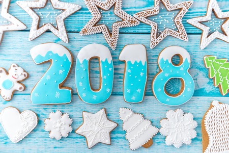 Gingerbread cookies, snowflakes hanging with ribbon over a blue wood background. Free space copyspace for your text. 2018 New Yearの写真素材