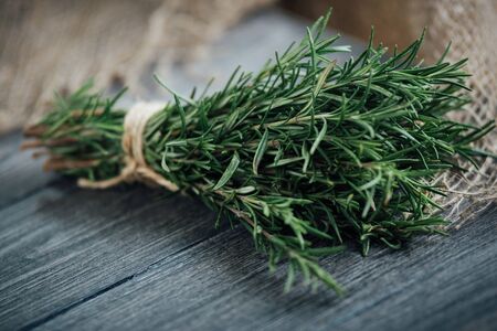 Organic bunch of fresh rosemary on the table.の写真素材