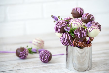 Colorful cake pops on a white wall background.の写真素材