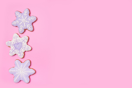 Christmas gingerbreads stars snowflakes on sweet pink background.Top view image. Copyspace for your textの写真素材