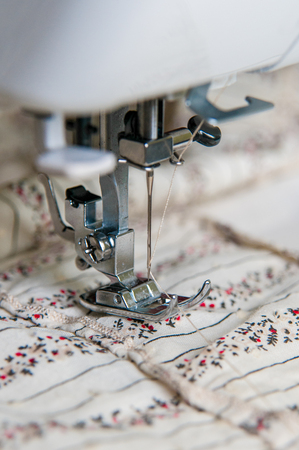Modern Sewing machine with light flower pattern fabricの写真素材