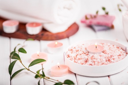 Handmade Salt Peach Scrub With Argan Oil. Himalayan Salt. Toiletries, Spa Set with candles and white towel.の写真素材