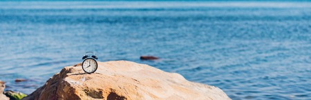 Morning of a new day, alarm clock on the beach sunlight in morning. Health and travel conceptの写真素材
