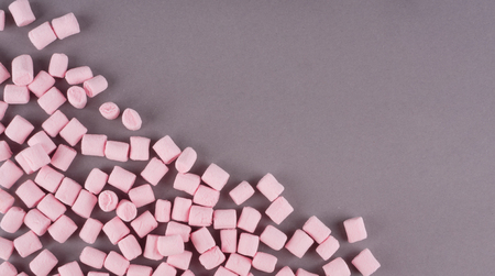 Colorful marshmallow laid out on gray paper background. pastel creative textured pattern. minimal styleの写真素材